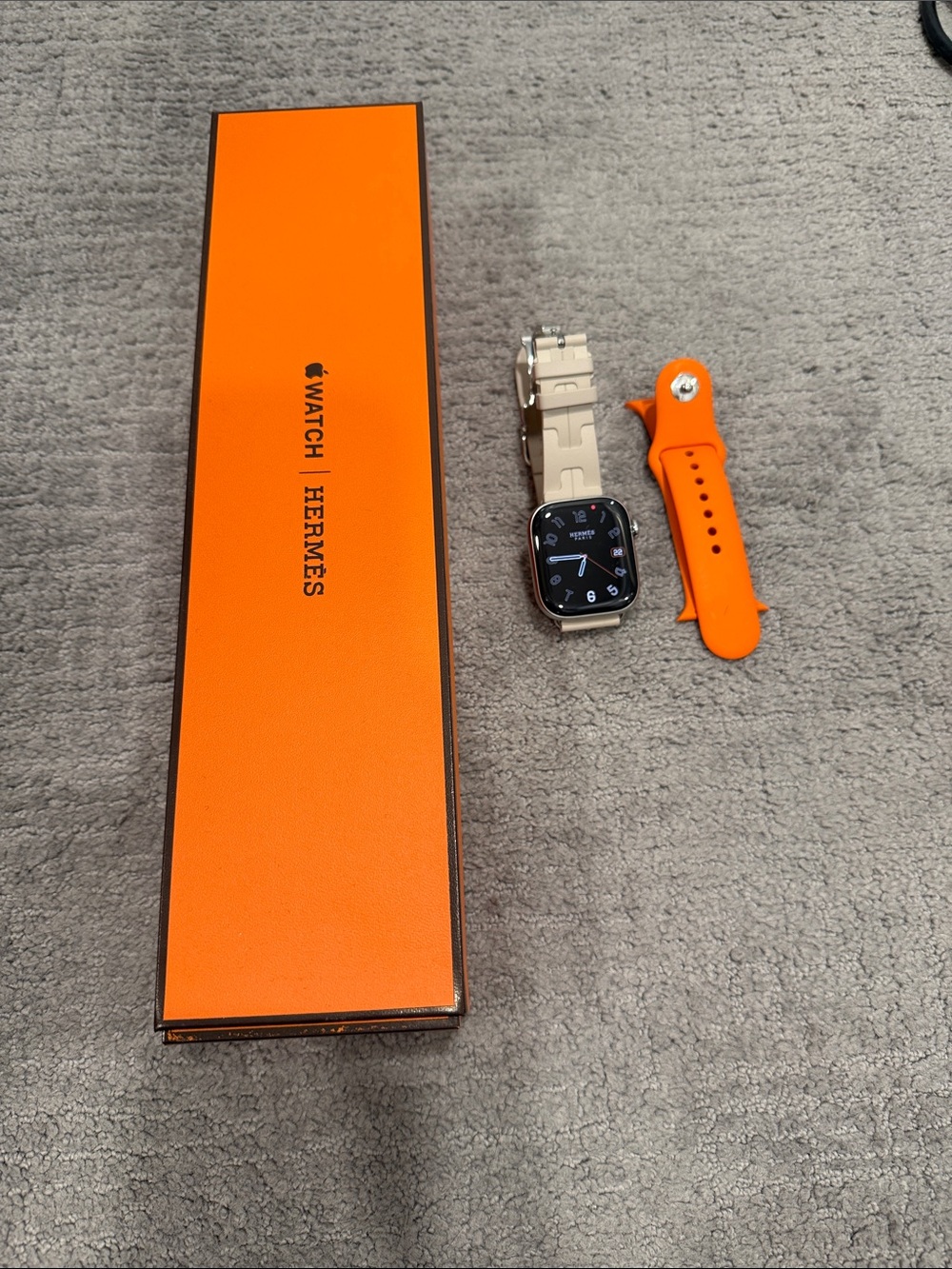Hermes Apple Watch Series 10 with Orange Sport Band and Silver Bracelet